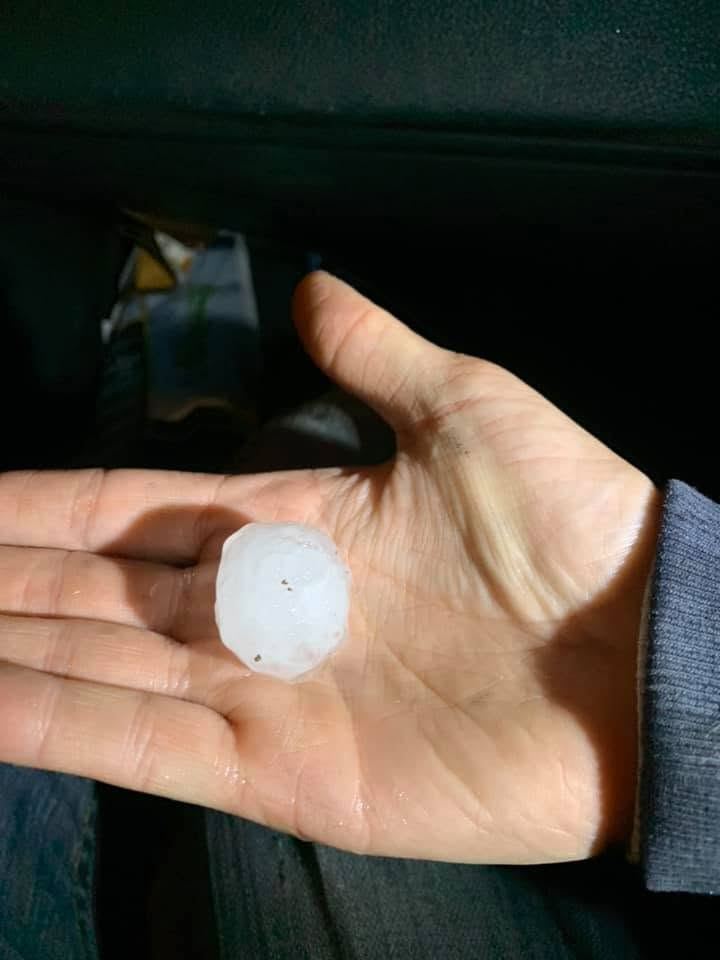 Large hailstone held in a hand after a Western New York storm
