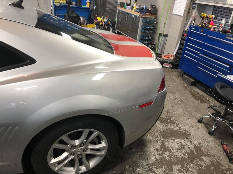 The same Camaro quarter panel after paintless dent repair with the dent completely removed