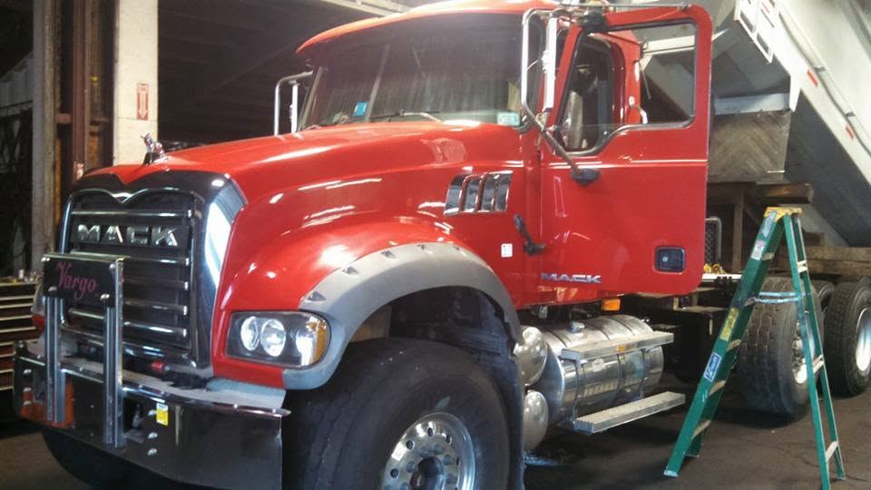 Red Mack commercial truck in the shop for paintless dent repair